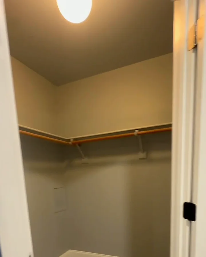 Walk-in closet with fresh paint and a new wood rod and shelf