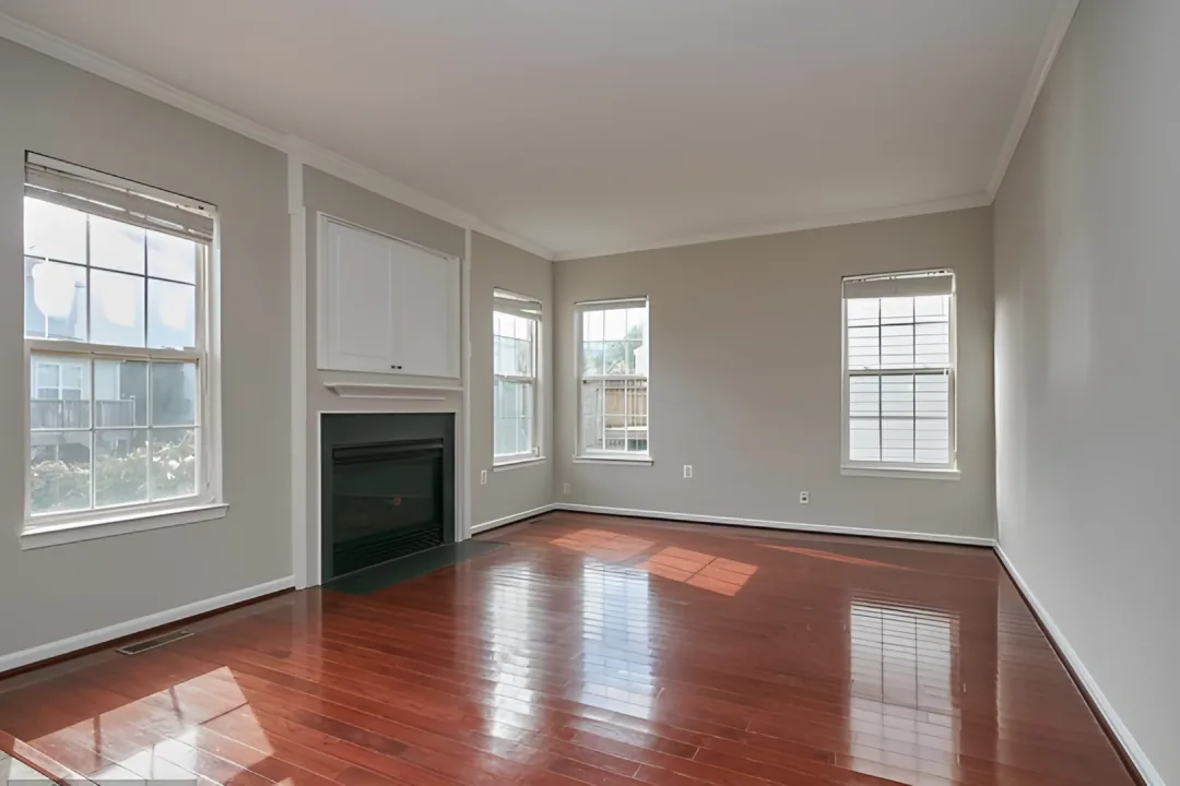 Living room before: plain painted wall around a basic fireplace